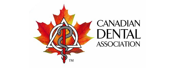 The logo of the Canadian Dental Association, featuring a stylized snake around a triangle and a rod symbol, with a red maple leaf in the background and the organization's name in black text on the right - Georgina Family Dental