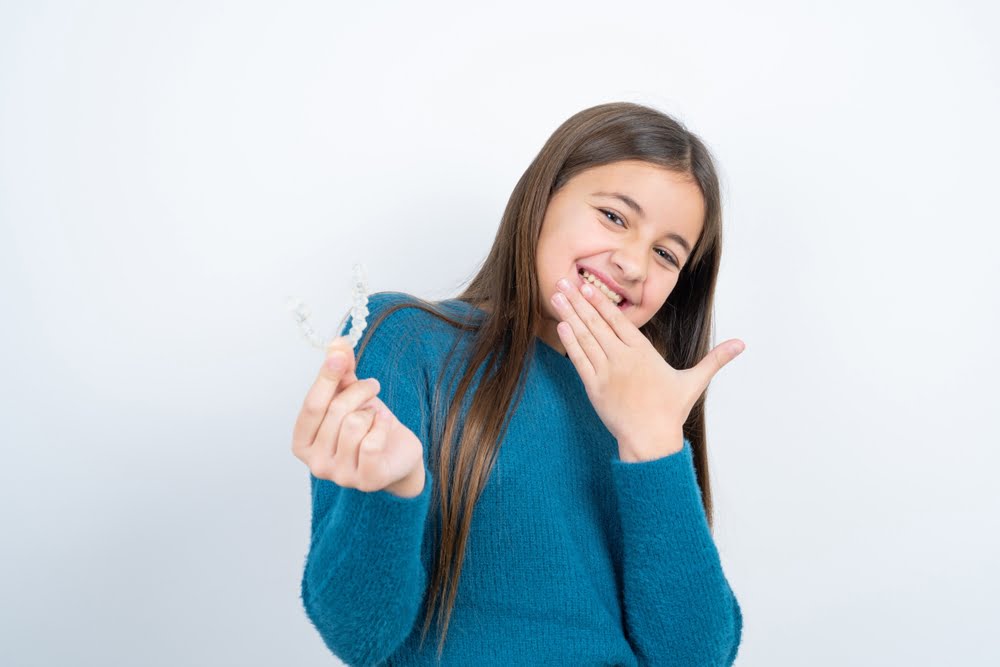 beautiful kid girl wearing blue t-shirt - Invisalign in Georgina, ON