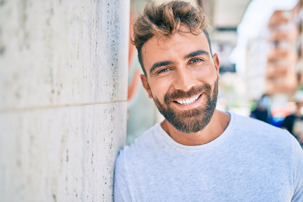 Bearded man leaning on a wall - Veneers in Georgina, ON