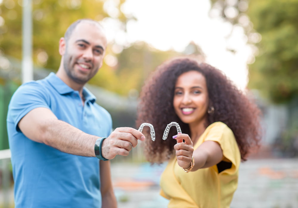 Couple holding Invisalign - Invisalign in Georgina, ON