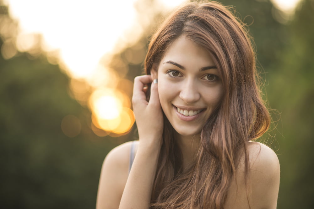 Woman smiling outdoors - Dental Emergency in Georgina, ON